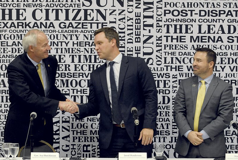 NWA Democrat-Gazette/DAVID GOTTSCHALK Arkansas gubernatorial candidates Governor Asa Hutchinson, Republican,(from left), Jared Henderson, Democrat, and Mark West, Libertarian, greet each other following a debate Friday, June 29, 2018, during the Arkansas Press Association Convention in Eureka Springs. Rusty Turner, editor Northwest Arkansas Democrat-Gazette, moderated the debate.