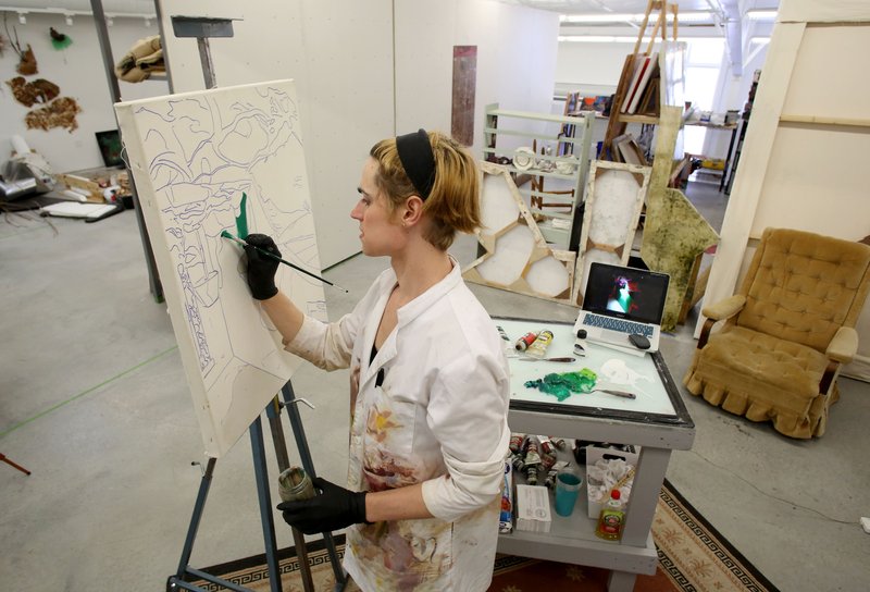 NWA Democrat-Gazette/DAVID GOTTSCHALK Hannah McBroom, a second year Master of Fine Arts student, works on an oil based painting Wednesday, August 23, 2017, inside her studio in the Sculptor Studio at the University of Arkansas Art and Design District in Fayetteville. The University of Arkansas will establish a School of Art in Fayetteville using a $120 million gift from the Walton Family Charitable Support Foundation, according to a press release today from the university. The money will provide financial support for students, regional outreach and public service through partnerships with Crystal Bridges Museum of American Art and expanded degree programs in art history, art education and graphic design.