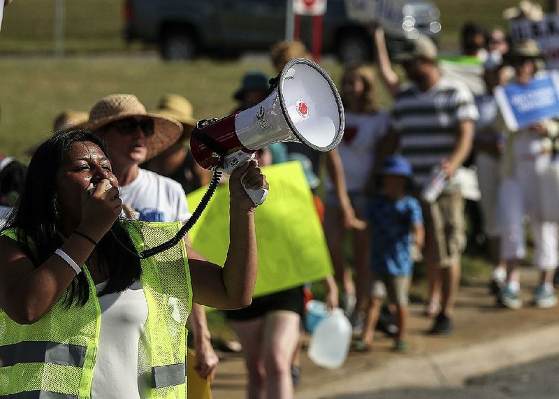 In Little Rock, Lesly Mendez, who will be a senior at Parkview Arts and Science Magnet High School in the fall, leads the crowd in chants as they march toward the state Capitol grounds. Rallies were also held in Conway, Hot Springs, Jonesboro, Fort Smith and Fayetteville.  