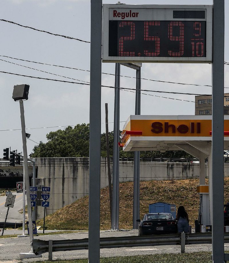 A motorist gets gas Saturday at the Shell station on Roosevelt Road and Interstate 30 in Little Rock. In Arkansas, the average price of a gallon of regular gasoline is 58 cents higher than it was a year ago. 