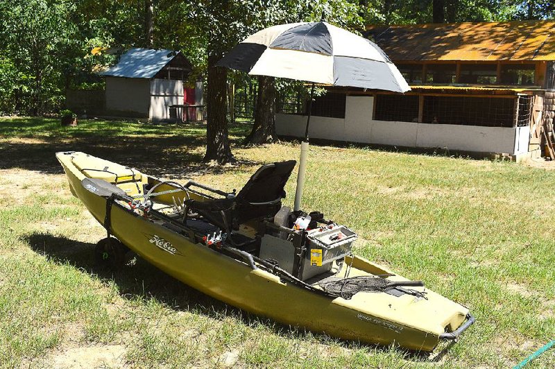A length of PVC and a golf umbrella combine to create a canopy in protecting kayak anglers from the summer sun. 