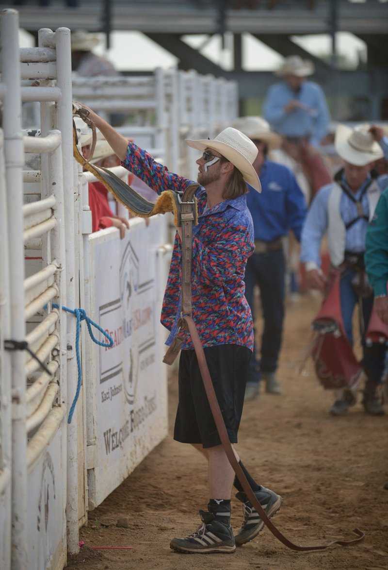 NWA Democrat-Gazette/ANDY SHUPE Logan Rudsell, 6, of Lowell waits Saturday, June 30, 2018, as his mother, Karissa Rudsell snaps in his helmet before he takes part in the mutton bustin' competition during the 74th Rodeo in the Ozarks at Parsons Stadium in Springdale. Visit nwadg.com/photos to see more photographs from the evening.