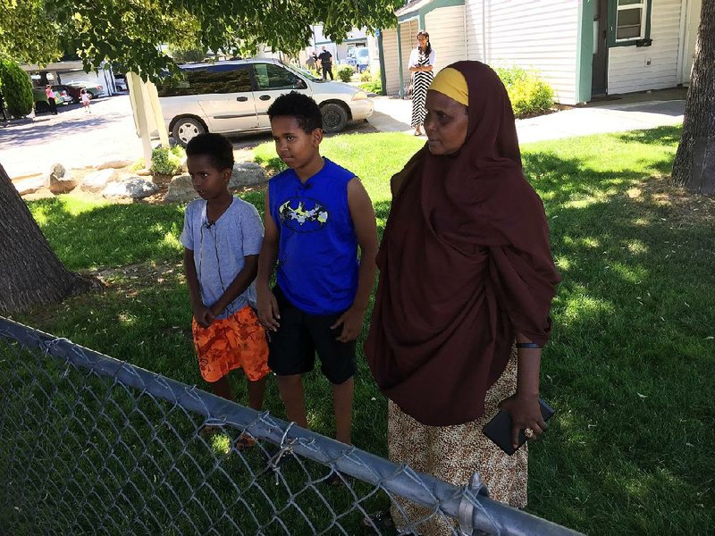 Fathi Mahamoud, 11, (left), Esrom Habte, 12, and Thado Aip on Sunday describe the attack Saturday night that left nine residents of their Boise, Idaho, apartment complex with stabbing injuries. (AP Photo/Rebecca Boone)