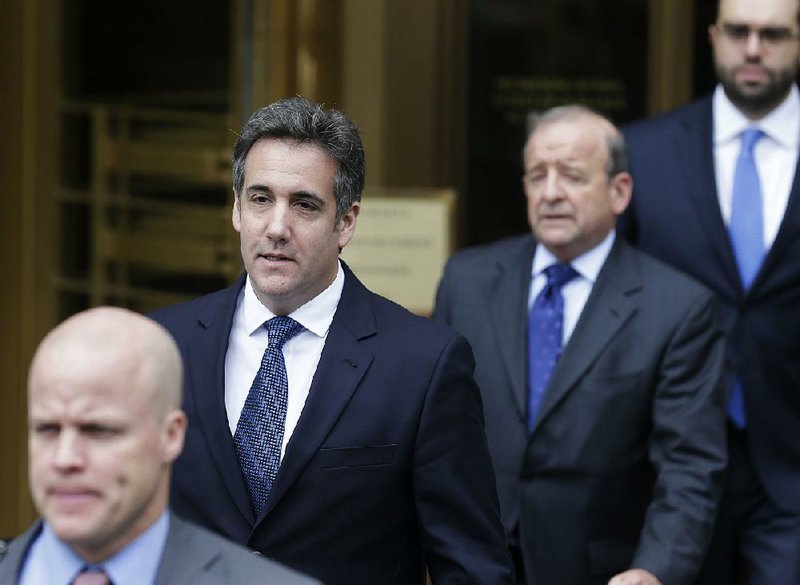 Michael Cohen (second from left), President Donald Trump’s longtime attorney, leaves court in New York on May 30. Cohen said he is ready to cooperate with federal prosecutors to protect his own family. (AP Photo/Seth Wenig, File)