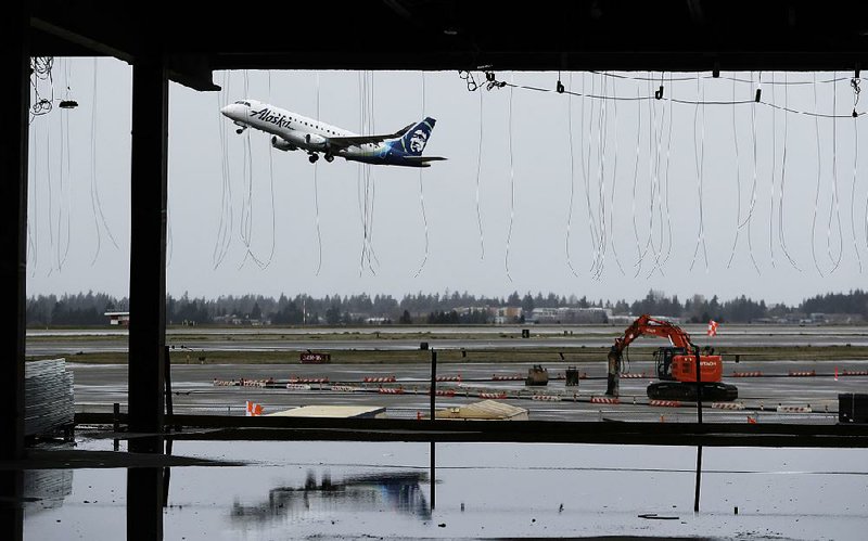 This April photo shows construction underway at Seattle-Tacoma International Airport. Airports across the country are spending record amounts on expansion and improvement projects. (AP Photo/Ted S. Warren)