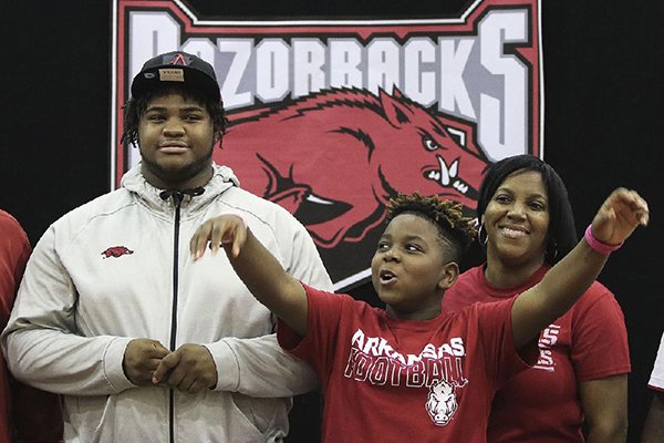 Arkansas Democrat-Gazette/STATON BREIDENTHAL --12/20/17--Fordyce's Billy Ferrell (left) along with his mother Rene Stuckey (right) and his younger brother Malik Harden, 12, call the Hogs Wednesday afternoon after Ferrell signed to play football at the University of Arkansas.