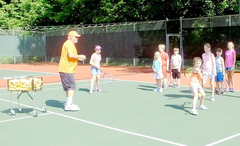 Lynn Atkins/The Weekly Vista Tennis Pro Jake Shoemake runs drills with junior tennis players on the Kingsdale Tennis courts last week. Another session of group lessons and two sessions of tennis camp are planned for this summer.