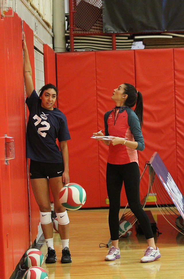 PHOTO COURTESY USA VOLLEYBALL Lizzy Briones, a coordinator of the USA Volleyball High Performance program, (at right) takes measurements of one of the athletes participating in one of their many camps across the country.