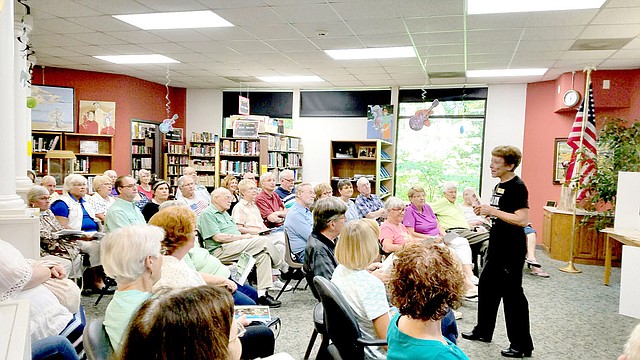 Photo submitted Xyta Lucas of the Bella Vista Historical Museum gives a presentation on the History of Wonderland Cave to a packed house at the Bella Vista Public Library, the first program for the Summer Speaker Series.