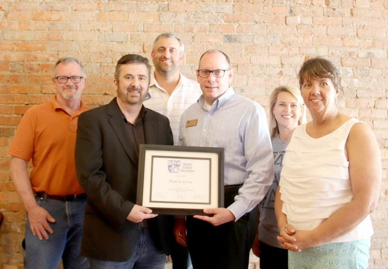 LYNN KUTTER ENTERPRISE-LEADER Greg Phillips, executive director of Main Street Arkansas, presents a certificate designating Prairie Grove as a member of the Arkansas Downtown Network to the city's Main Street Prairie Grove Advisory Board. Board members are Larry Williams, left, president Rick Ault, Dale Reed, Phillips, Shannon Stearman and Cathy Sargent. Not pictured are Kay Shreve and Mayor Sonny Hudson.