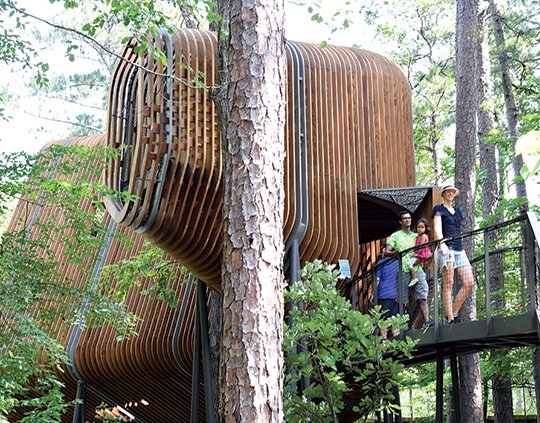 The Sentinel-Record/Grace Brown TREE HOUSE: The Colorado family, of Texas, exits the Bob and Sunny Evans Tree House in the Evans Children's Adventure Garden on Tuesday. Garvan Woodland Gardens hosted a soft opening on June 30 to celebrate the Tree House's completion.