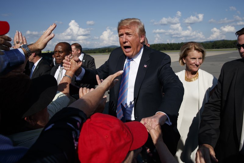 President Donald Trump greets supporters after arriving at the Greenbrier Valley Airport in Lewisburg, W.Va., before attending a "Salute to Service" dinner, Tuesday, July 3, 2018, in White Sulphur Springs, W.Va. (AP Photo/Evan Vucci)
