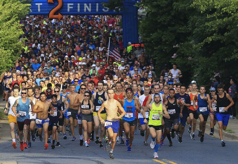 Runners break away from the starting line Wednesday morning during the Firecracker Fast 5K on Kavanaugh Boulevard in Little Rock. A total of 1,521 runners completed the event. See more photos at arkansasonline.com/galleries 