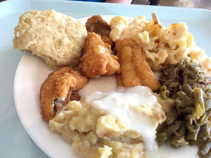 A Friday “Meat & Three” cafeteria-style plate lunch at Cathead’s Diner included fried catfish, green beans with bits of barbeued pork, macaroni and cheese, mashed potatoes with cream gravy and a cathead biscuit.  