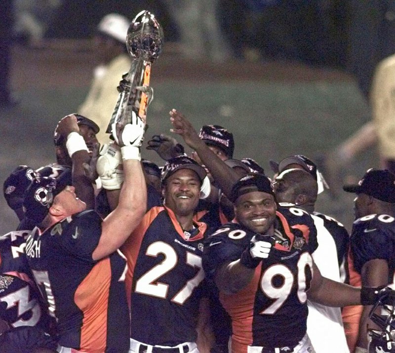 The Associated Press CHAMPION: Denver Broncos' Steve Atwater (27) and Neil Smith (90) celebrate their Super Bowl XXXII victory with teammates as they hold up the Vince Lombardi trophy after defeating the Green Bay Packers at San Diego's Qualcomm Stadium on Jan. 25, 1998. Atwater will be inducted into the Southwest Conference Hall of Conference in September.