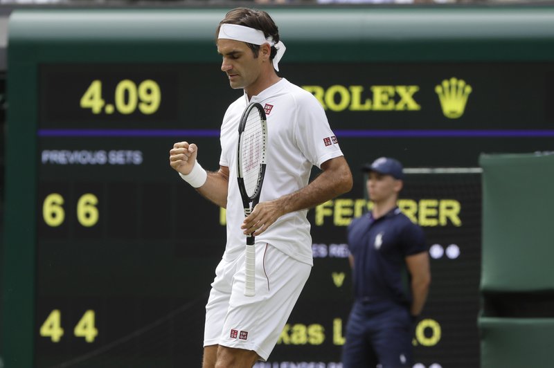 Switzerland's Roger Federer celebrates his match point against Slovakia's Lukas Lacko in their men's singles match, on the third day of the Wimbledon Tennis Championships in London, Wednesday July 4, 2018. (AP Photo/Kirsty Wigglesworth)