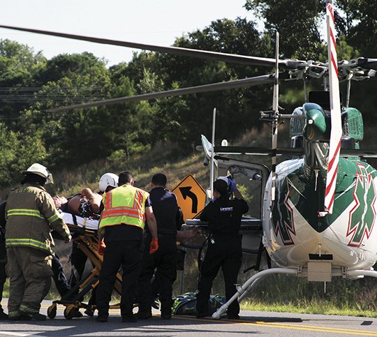 A unidentified person is placed in a Lifenet Helicopter on Wednesday, July 4, after a report of a boating incident on Lake Hamilton around 4:30 p.m. Seargent David Martineau said that Garland County Marine Patrol responded to the incident and Garland County Sheriff's blocked the roadway of Carpenter Dam Road near Entergy Park. (The Sentinel-Record/Rebekah Hedges)