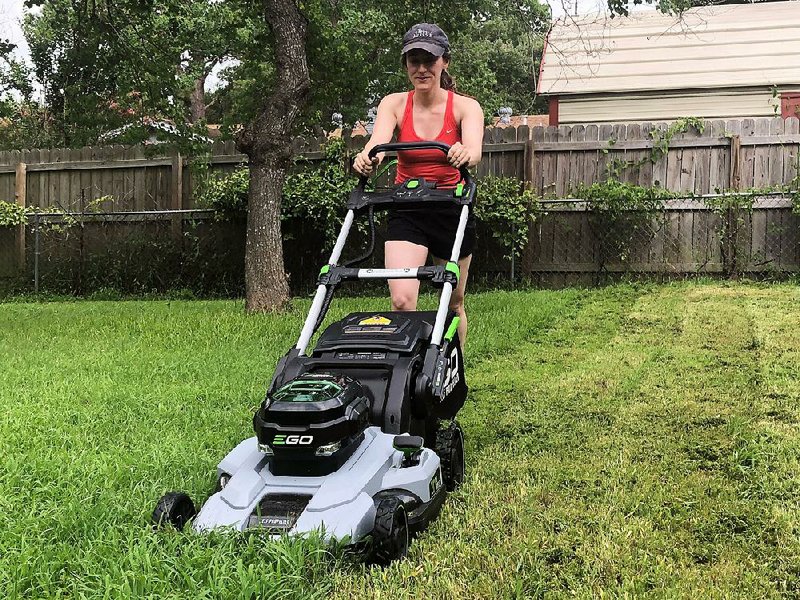 The author’s daughter, Paige Roth, test drives the next generation of lithium-battery-powered mowers, which are greener, cleaner and quieter.  