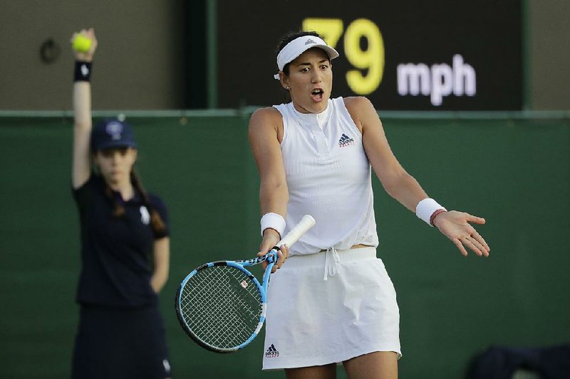 Garbine Muguruza of Spain gestures Thursday after losing a point to Alison Van Uytvanck of Belgium at Wimbledon. The third-seeded Muguruza went on to lose the match in three sets.  