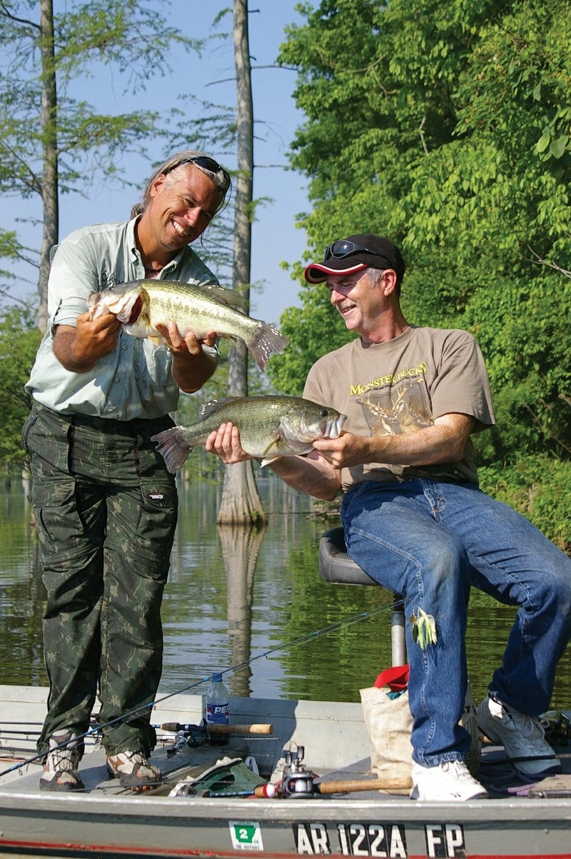A morning of cypress-lake fishing in south Arkansas produced these lunker largemouths for Gary Looney of Wynne, right, and visiting angler Ian Sulocki of Manaus, Brazil.