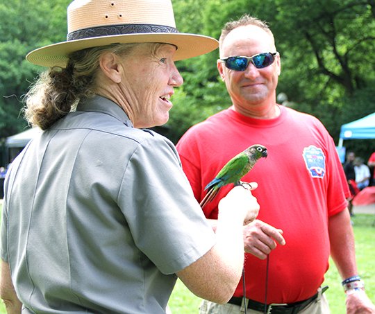 The Sentinel-Record/Beth Reed
Sheila Malone, park interpreter for Hot Springs National Park, holds Spyk, a 5-year-old conure as Billy Hoda looks on. Hoda was a volunteer for the inaugural Red, White and You picnic on Arlington Lawn Wednesday, hosted by Friends of Hot Springs National Park.