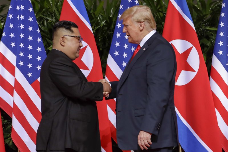 FILE - In this June 12, 2018, file photo, U.S. President Donald Trump, right, shakes hands with North Korean leader Kim Jong Un at the Capella resort on Sentosa Island in Singapore. In his first post-summit visit to Pyongyang, U.S. Secretary of State Mike Pompeo is hoping to pin Kim down on all the things the North Korean leader danced around in his talks with Trump in Singapore. (AP Photo/Evan Vucci, File)