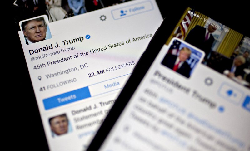 The Twitter accounts of President Donald Trump, @POTUS and @realDoanldTrump, are seen on an Apple iPhone in Washington on Jan. 27, 2017.