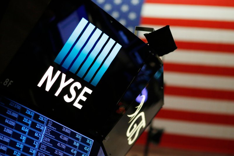 FILE - In this Dec. 27, 2017, file photo, a logo for the New York Stock Exchange is displayed above the trading floor. (AP Photo/Mark Lennihan, File)