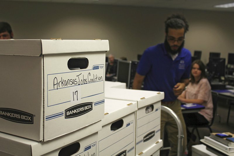 Boxes containing petitions in favor of a proposal to legalize casinos in Arkansas are delivered to the Arkansas secretary of state's office Friday, July 6, 2018, in Little Rock.