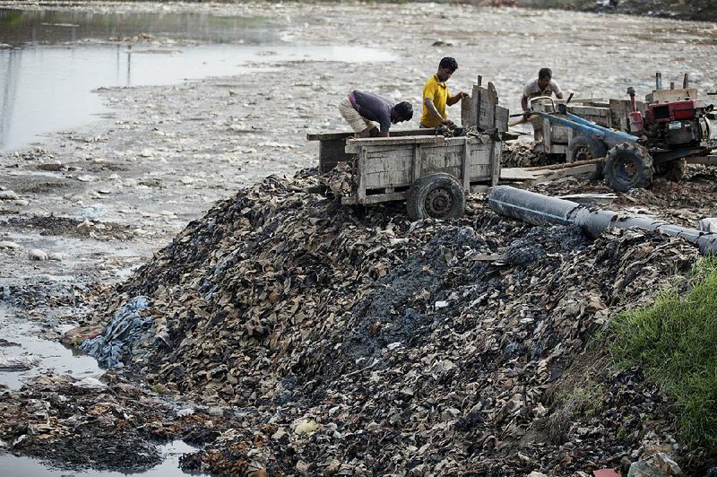 Workers unload tannery waste in June at an industrial complex on the banks of the Daleshwari River in Savar, Bangladesh.  