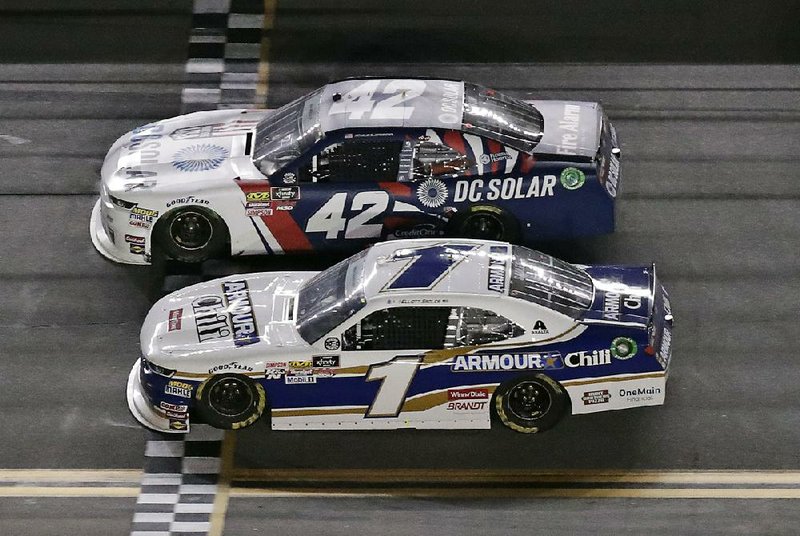 Kyle Larson (42) beat Elliott Sadler (1) to the finish line by .005 seconds to win Friday night’s NASCAR Xfinity Series race at Daytona International Speedway.