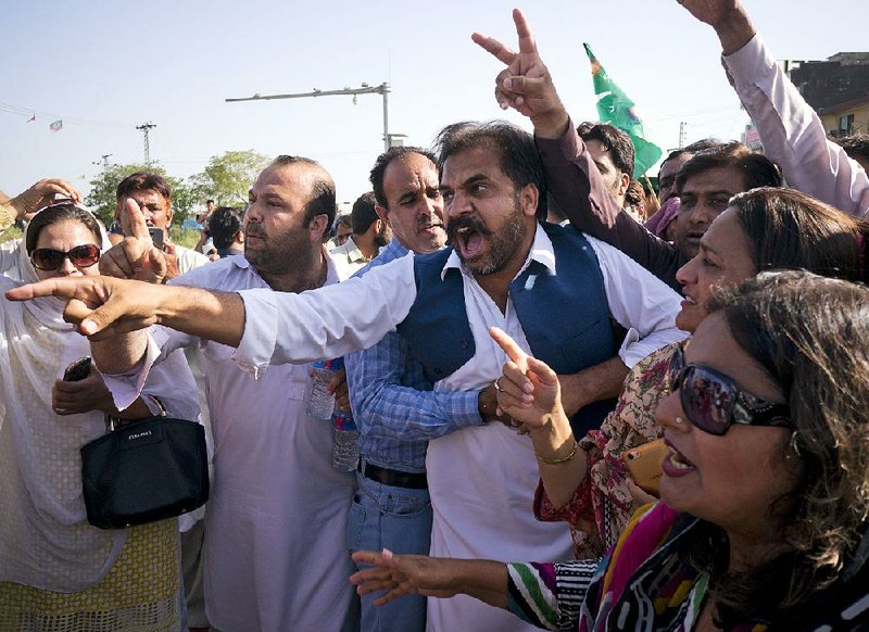 Supporters of former Pakistani Prime Minister Nawaz Sharif react upon hearing about his prison sentence Friday in Islamabad. 