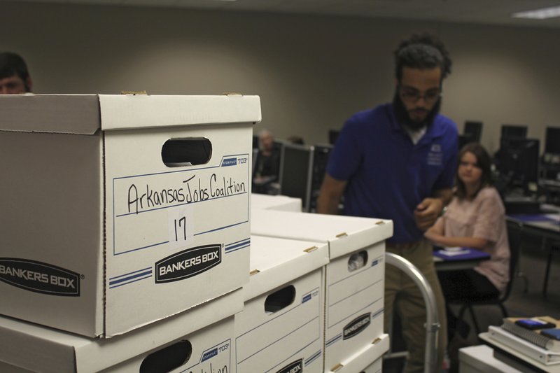 Boxes containing petitions in favor of a proposal to legalize casinos in Arkansas are delivered to the Arkansas secretary of state's office on Friday, July 6, 2018 in Little Rock, Ark. Friday was the deadline for ballot measure groups to submit signatures to try and get their proposals on the November ballot. (AP Photo/Andrew Demillo)