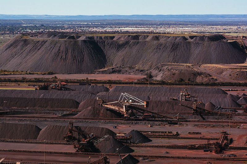 Stackers drop iron ore into piles in May at the Sishen open cast mine, operated by Kumba Iron Ore in Sishen, South Africa. 