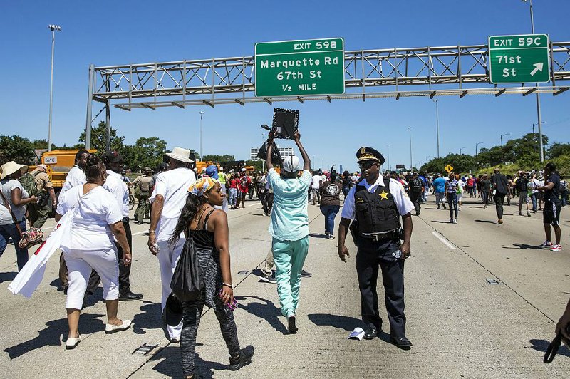 People gather Saturday on Interstate 94 in Chicago for a protest against gun violence.  