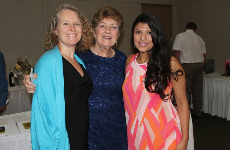 NWA Democrat-Gazette/CARIN SCHOPPMEYER Kathleen Trotter, Arts Live Theatre honoree (center) visits with Nancy Reid (left) and Ana Aguayo at the theater's Laugh Out Loud benefit June 23 at the Fayetteville Town Center.