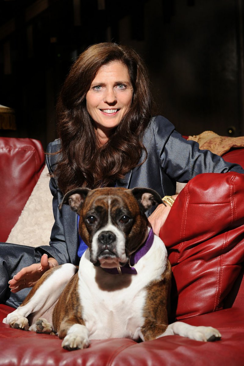 NWA Media/ANDY SHUPE - Betsy Broyles Arnold, seen here with her dog, Emma, is the daughter of longtime University of Arkansas football coach and athletics director Frank Broyles and is the founder of the Broyles Foundation/Caregivers United. Thursday, July 3, 2014.