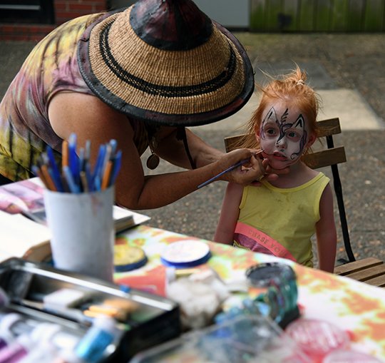 The Sentinel-Record/Grace Brown- Addy Kirk, 4, of North Little Rock gets her face painted by Karen Scabrini of Mt. Ida at Adair Park on Sunday, July 1, 2018. Scabrini says she and magician Melvin &#x201a;&#xc4;&#xfa;Jamel the Magician&#x201a;&#xc4;&#xf9; Brown regularly come to the park to provide entertainment for tourists.