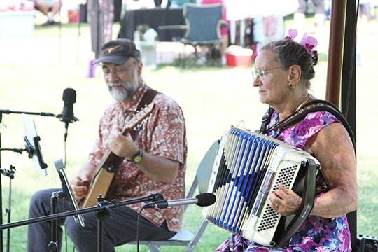 Bob Nagy and Barbara Muller play live polka music in the Farmer's Market on Saturday. Their musical group known as &quot;Europa&quot; played music inspired from trips through Europe. (The Sentinel-Record/Rebekah Hedges)