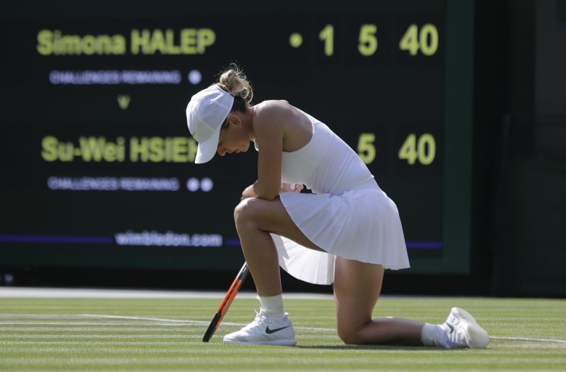 The Associated Press DOWN AND OUT: Simona Halep of Romania loses a point to Hsieh Su-Wei of Taiwan during their women's singles match Saturday on the sixth day at the Championships, Wimbledon in London. The 48th-ranked Hsieh defeated the top-ranked Halep 3-6, 6-4, 7-5 in the third round.