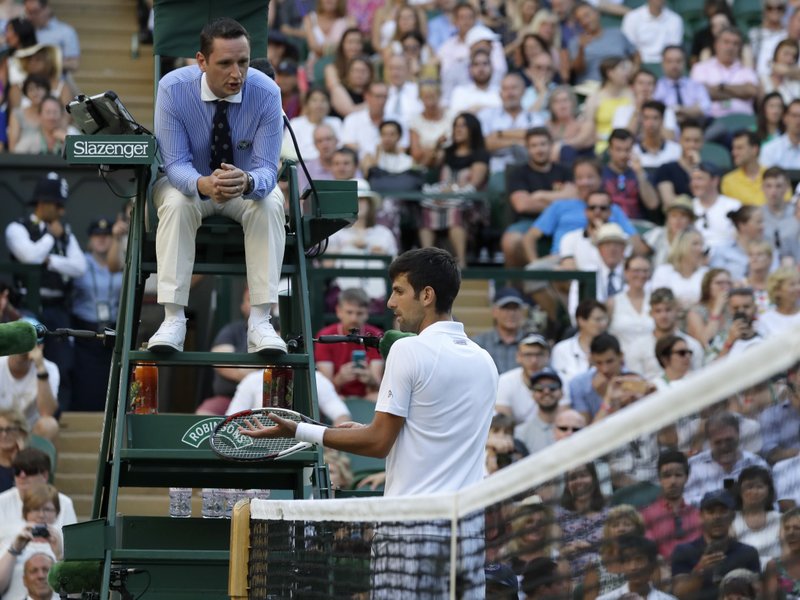 The Associated Press BAD CALL: Serbia's Novak Djokovic complains to the umpire during his men's singles match against Kyle Edmund, of Great Britain, Saturday on the sixth day of the Championships, Wimbledon in London. Djokovic defeated the home favorite 4-6, 6-3, 6-2, 6-4.