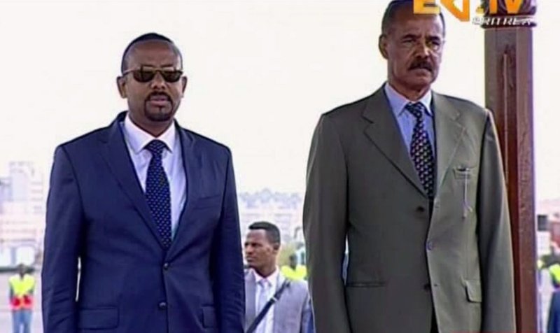In this grab taken from video provided by ERITV, Ethiopia's Prime Minister Abiy Ahmed, left and Erirea's President Isaias Afwerki observe the Guard or Honour during a welcome ceremony for Ahmed, in Asmara, Eritrea, Sunday, July 8, 2018. With laughter and hugs, the leaders of longtime rivals Ethiopia and Eritrea met for the first time in nearly two decades Sunday amid a rapid and dramatic diplomatic thaw aimed at ending one of Africa's longest-running conflicts. (ERITV via AP)