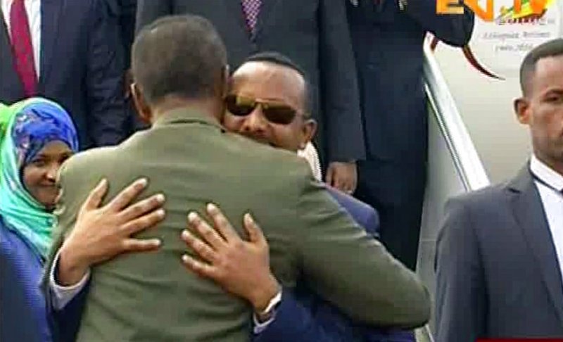 In this grab taken from video provided by ERITV, Ethiopia's Prime Minister Abiy Ahmed, background centre is welcomed by Erirea's President Isaias Afwerki as he disembarks the plane, in Asmara, Eritrea, Sunday, July 8, 2018. 