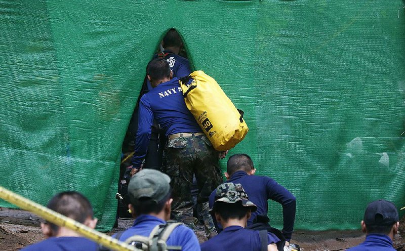 Rescuers arrive Sunday in Mae Sai, Thailand, near a cave where 12 boys and their soccer coach have been trapped since June 23.