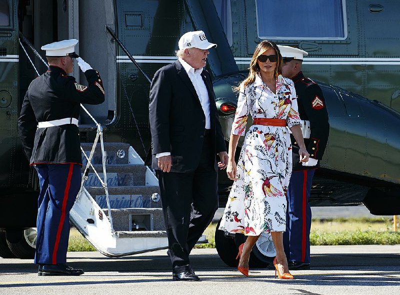 President Donald Trump and first lady Melania Trump walk from Marine One to board Air Force One at Morristown Municipal Airport, in Morristown, N.J., Sunday, July 8, 2018, en route to Washington from Trump National Golf Club in Bedminster, N.J. (AP Photo/Carolyn Kaster)