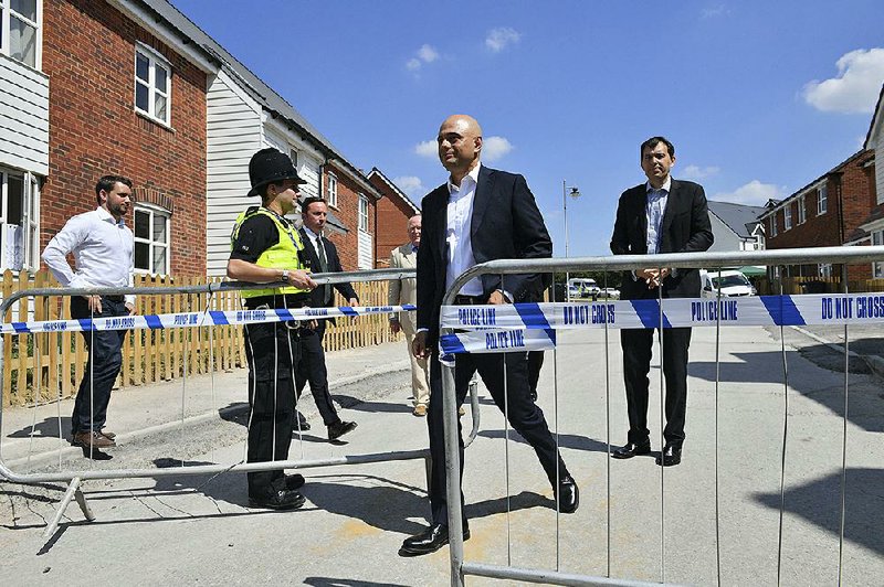 Britain’s Home Secretary Sajid Javid exits the police cordon Sunday at Muggleton Road where counter-terrorism officers are investigating how a couple were exposed to the nerve agent Novichok, in Amesbury, England, in late June. 
