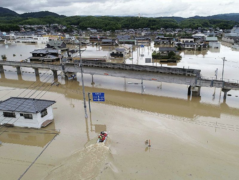 Houses are partly submerged in floodwaters from heavy rains, in Kurashiki, Okayama prefecture, southwestern Japan, on Sunday.