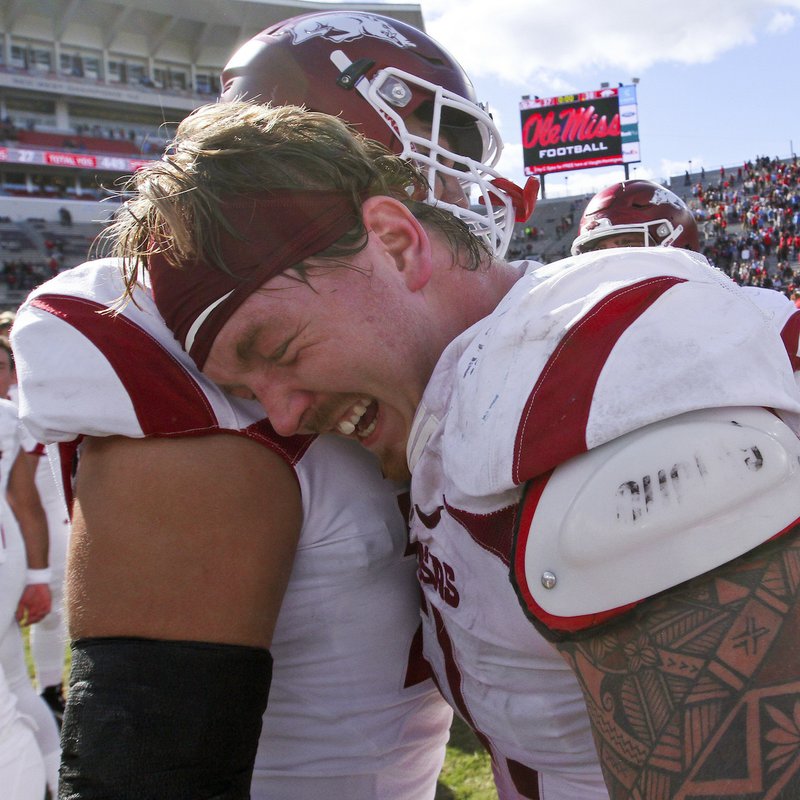 Arkansas Deocrat-Gazette/BENJAMIN KRAIN --10/28/17--
Arkansas offensive linemen Hjalte Froholdt (51), center, and Paul Ramirez (76), left, celebrate after defeating Ole Miss by 1 point with a field goal in the final seconds of the game during their 38-37 victory.