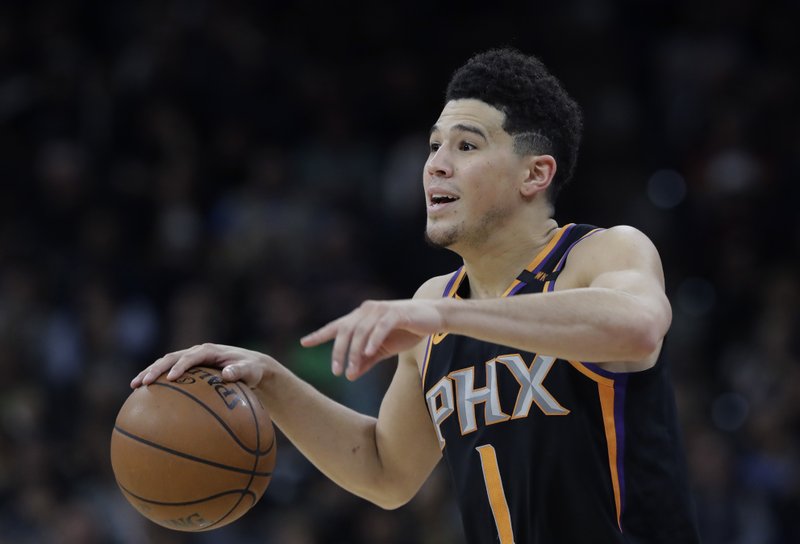 The Associated Press BRIGHT STAR: Phoenix Suns guard Devin Booker (1) gestures during the second half of the team's NBA game Jan. 5 against the San Antonio Spurs in San Antonio. Booker, the high-scoring guard at the heart of Phoenix's rebuilding plans, has signed a five-year, $158 million maximum contract with the Suns. Booker, 21, tweeted a photo of himself smiling as he signed the deal Saturday night, moments before the Suns announced the deal.