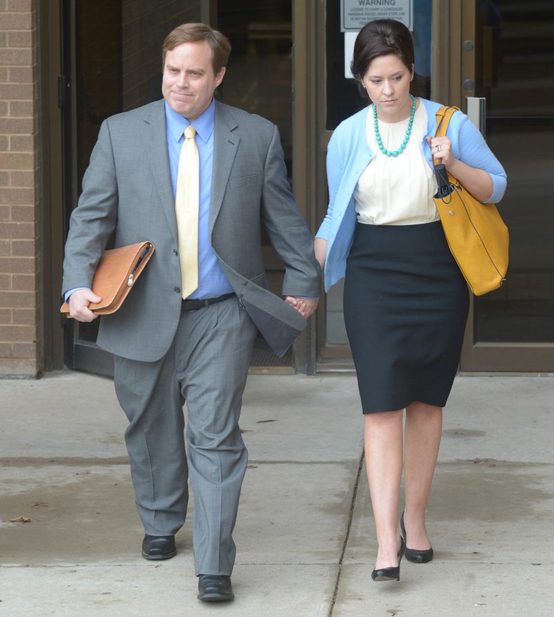 NWA Democrat-Gazette/ANDY SHUPE Former state senator Jon Woods and his wife Christina walks outside the John Paul Hammerschmidt Federal Building May 3, the in Fayetteville. Woods and Randell Shelton Jr. were found guilty on multiple corruption charges.